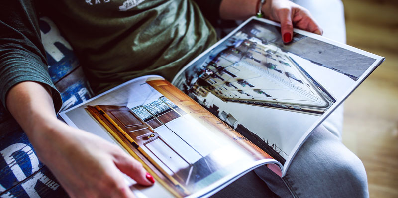 A woman reading an architectural catalog.